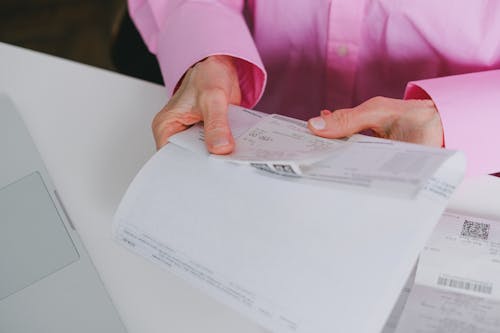 Free Person Holding a Receipt Stock Photo