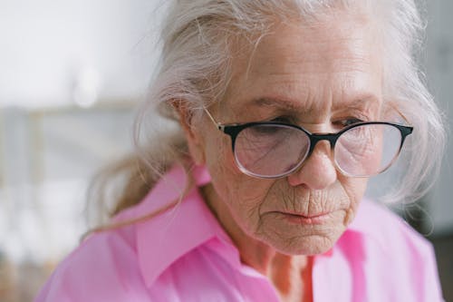 Close-Up Shot of an Elderly Woman with Eyeglasses 