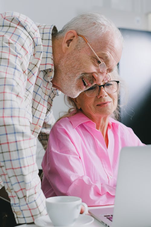 Elderly Couple Looking at Laptop