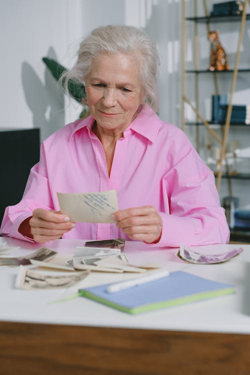 Happy Elderly Women Reminiscing About Their Old Photos · Free Stock Photo