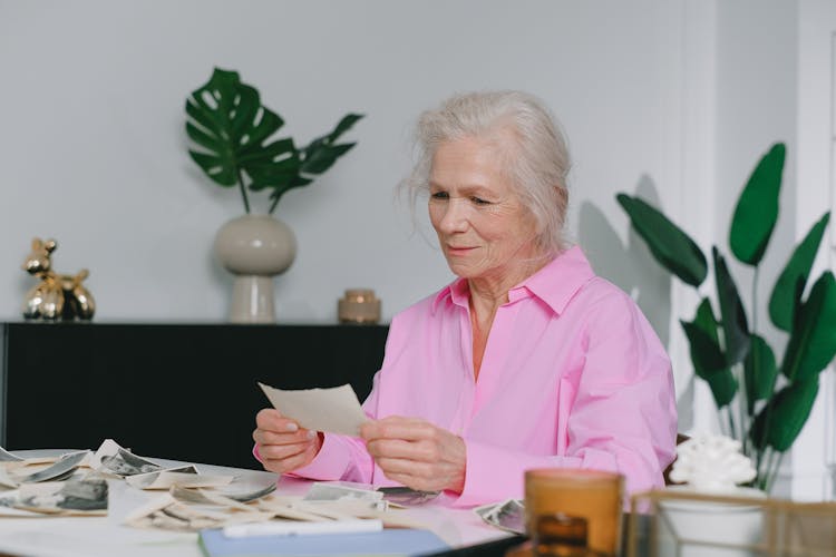 An Elderly Woman Holding A Photo