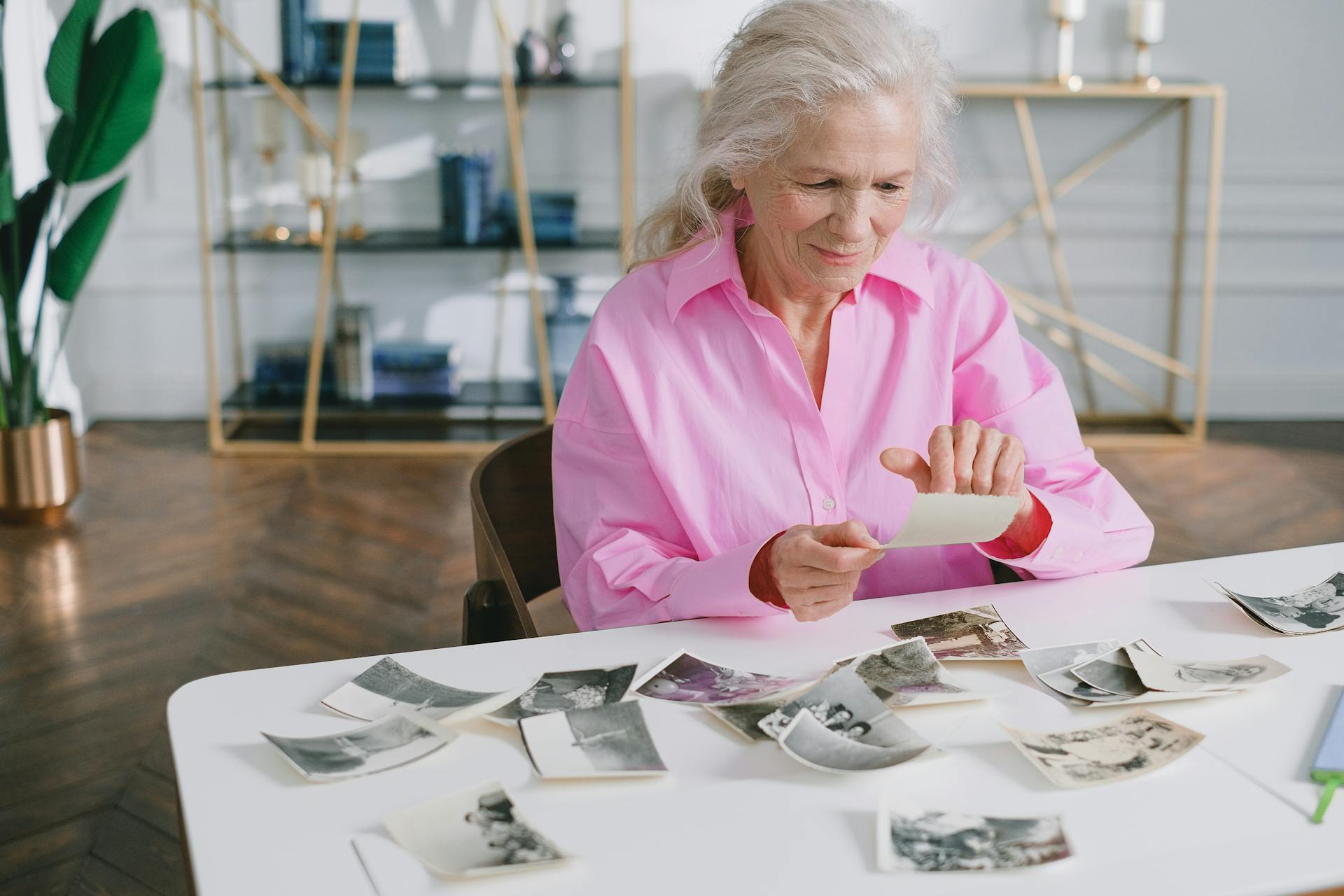 Senior Woman Browsing Through Old Photographs at Home