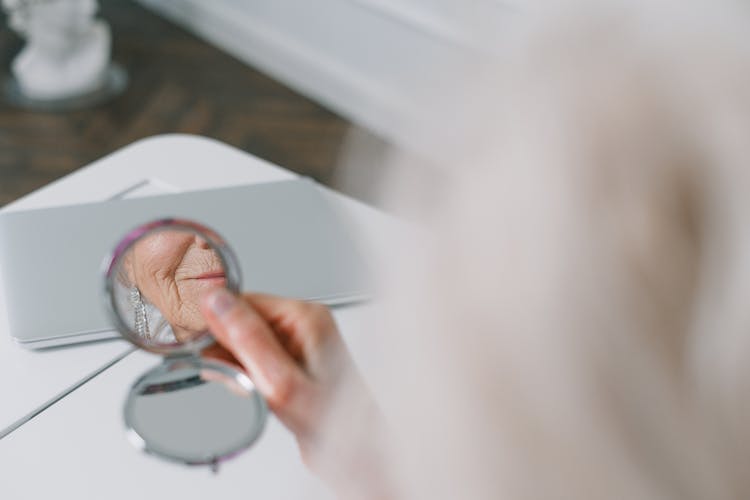 Person Holding A Round Mirror