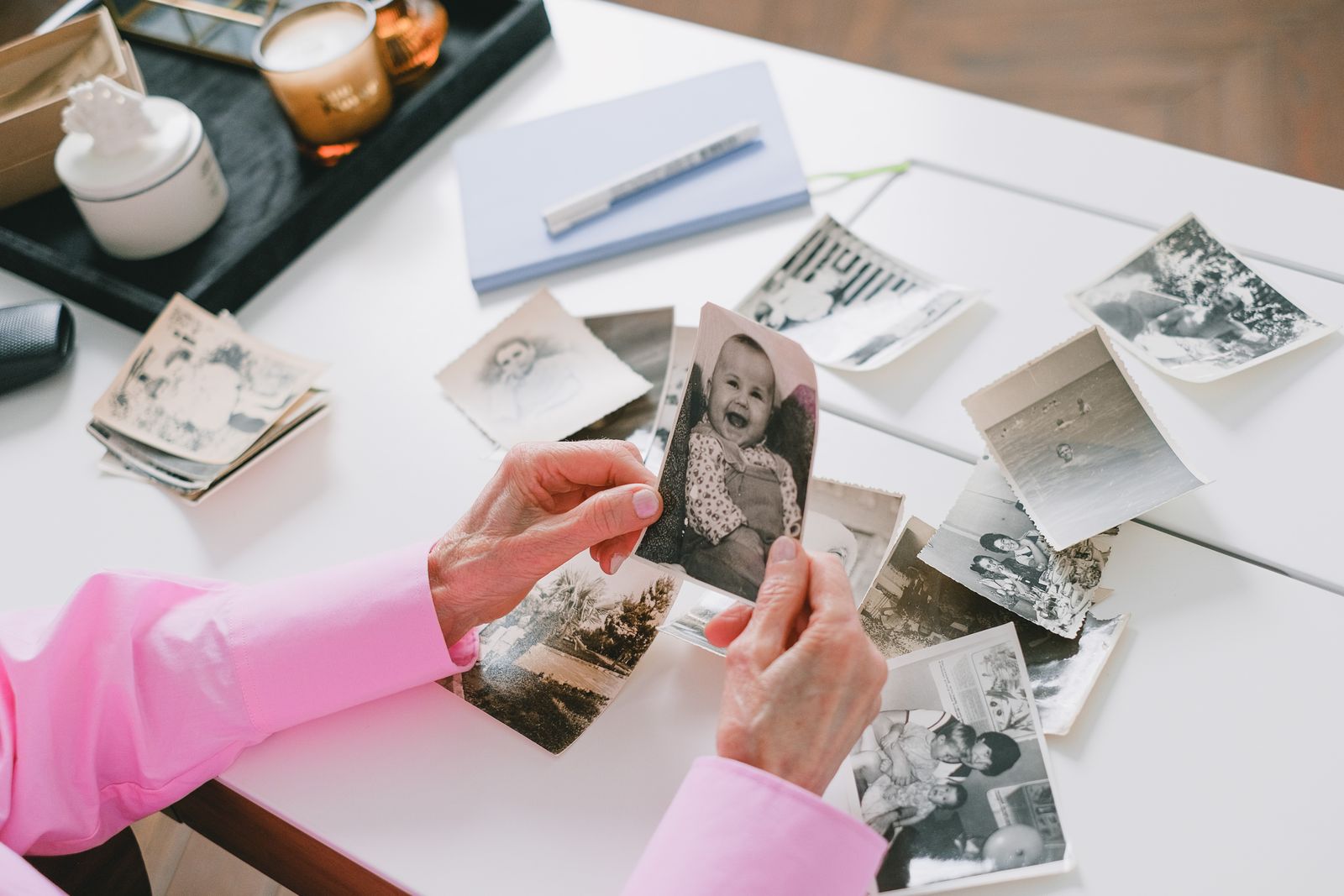 Hands sorting meaningful vintage family photographs