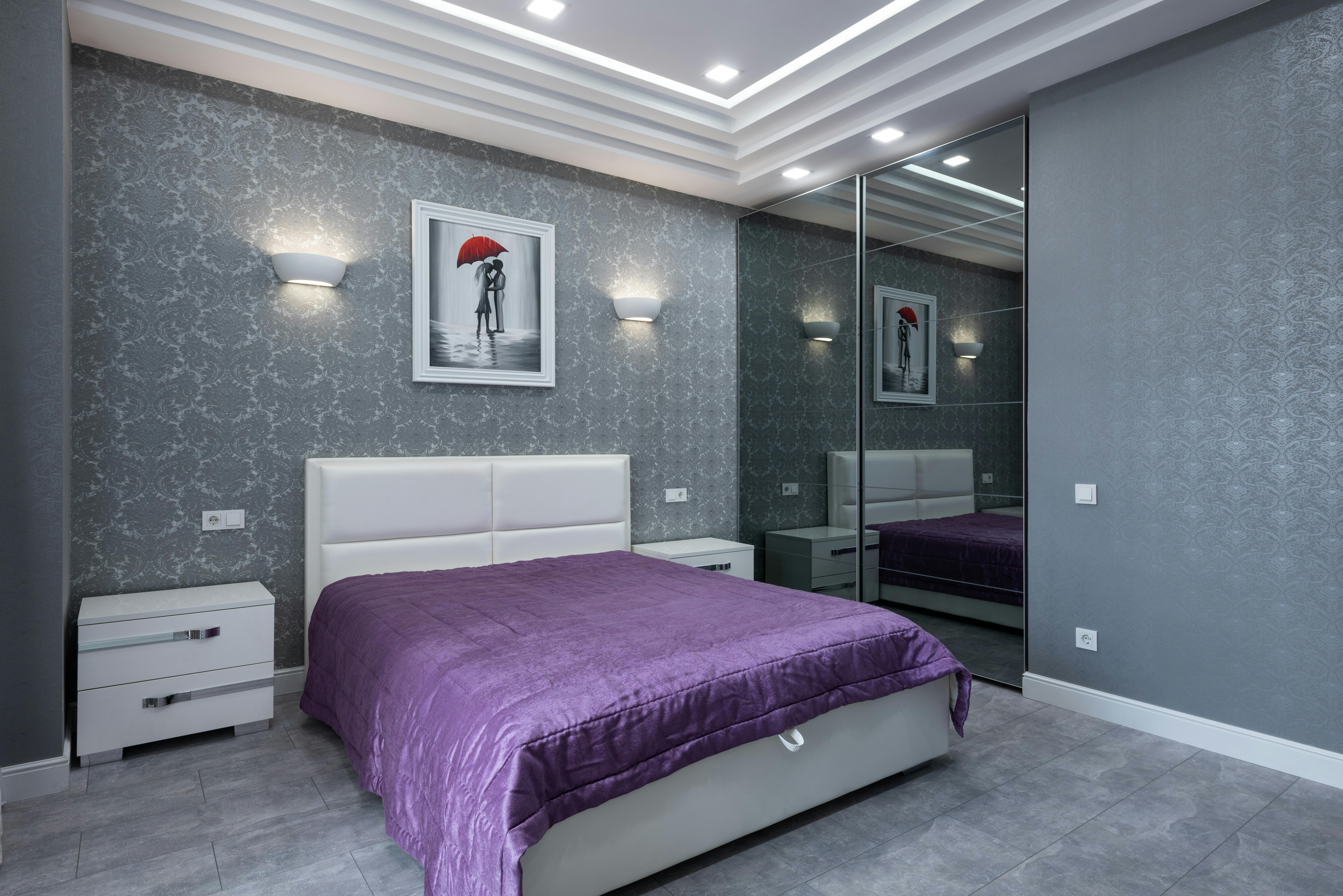 interior of bedroom with large bed and gray walls