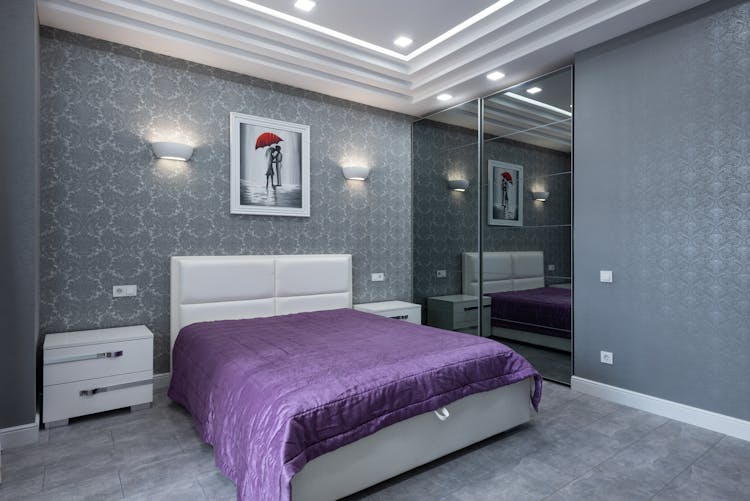 Interior Of Bedroom With Large Bed And Gray Walls