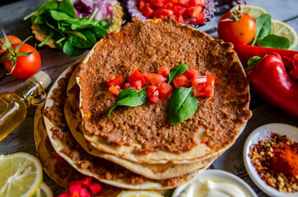 Stacked flatbreads topped with peppers and tomato — photo by Fauzan Fitria on Pexels