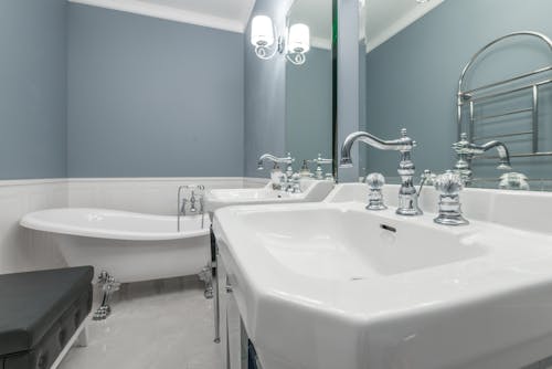 Interior of bathroom with clean sinks and bathtub