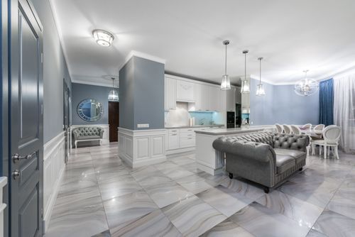 Free Bright open-concept kitchen and living area featuring modern design with stylish furniture and decor. Stock Photo