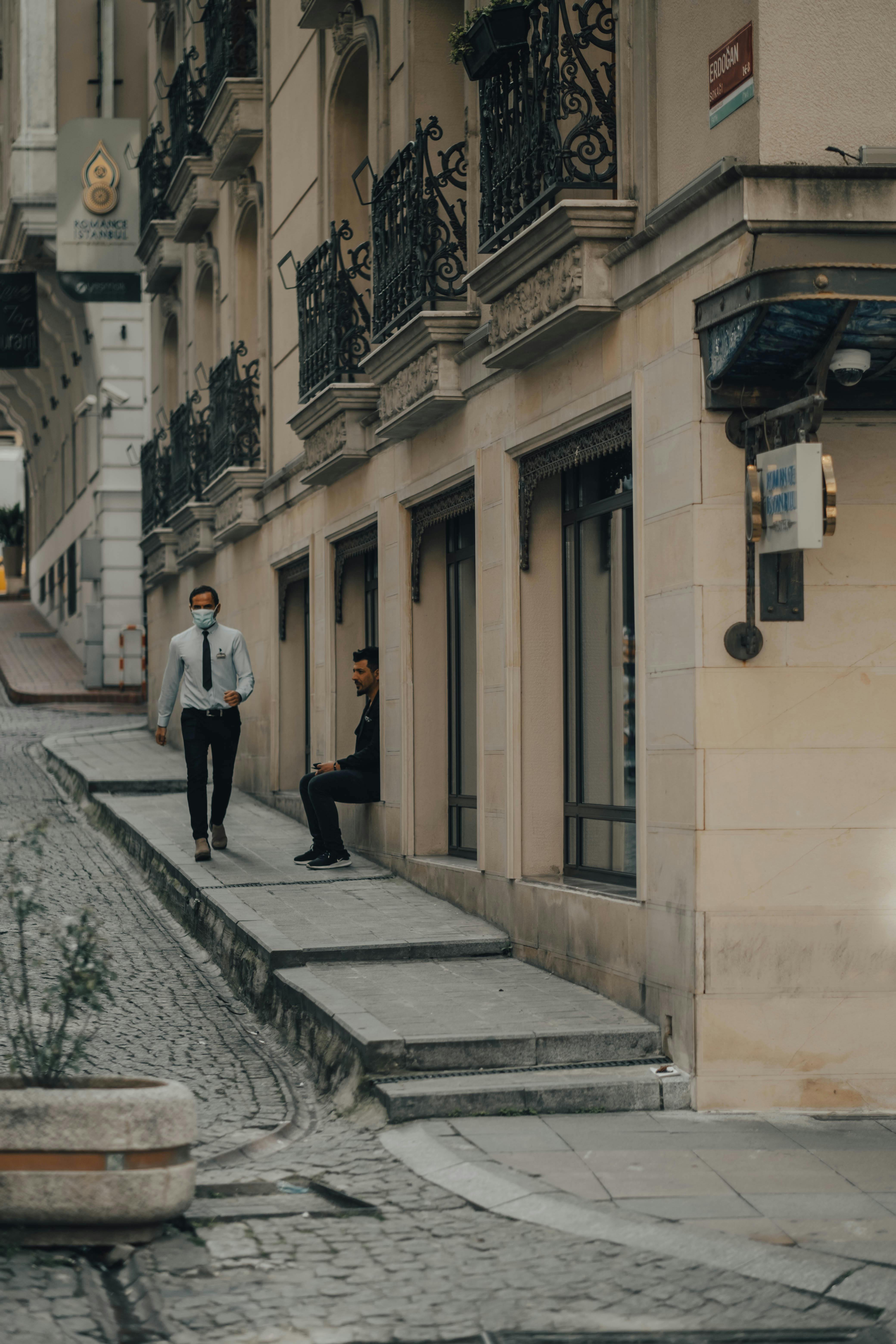 Town district with pedestrians on sidewalk near buildings · Free Stock ...