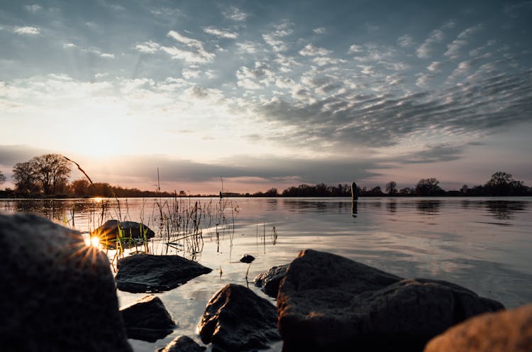 Rocks On The Lake During Sunset