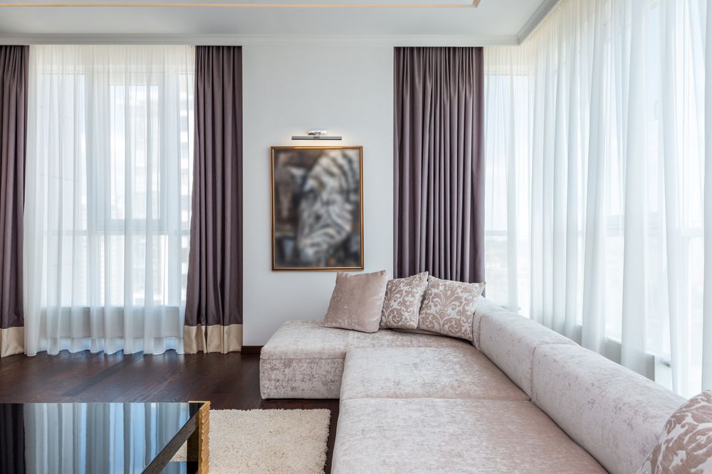 Bright living room with sectional sofa and large windows