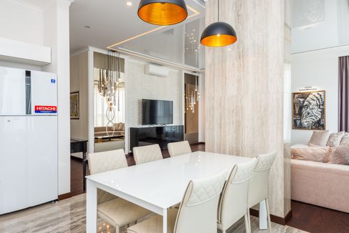 Free A contemporary dining room with elegant chairs and pendant lighting, creating a chic ambiance. Stock Photo