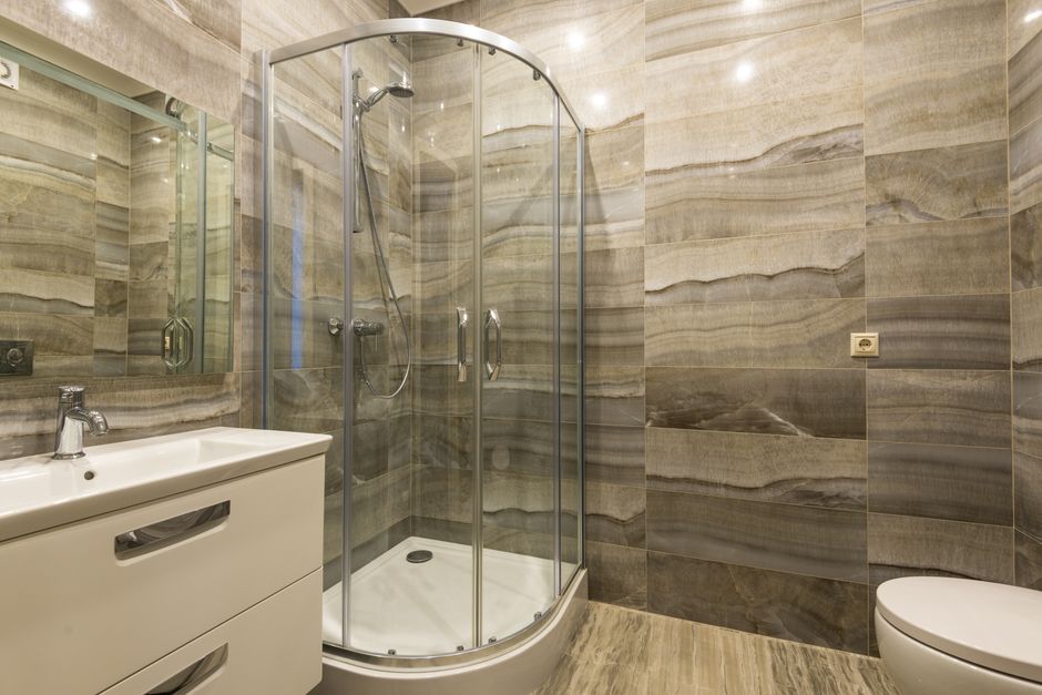 Luxurious modern bathroom featuring a glass shower and stylish sink setup.