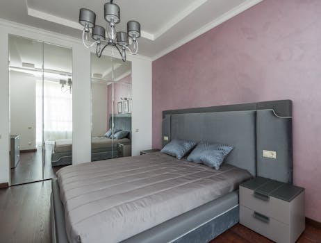 Contemporary bedroom interior design featuring elegant furnishings and a soft color palette.