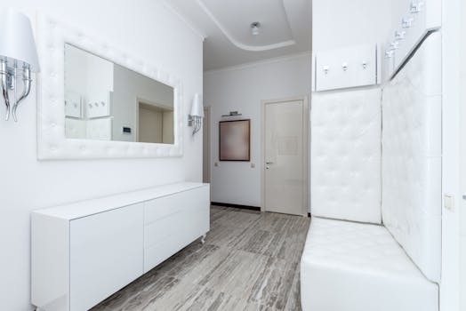 Bright minimalist hallway interior with white decor and modern furniture.