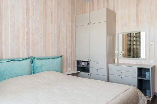 Free Contemporary bedroom featuring sleek furniture and soft teal accents. Stock Photo
