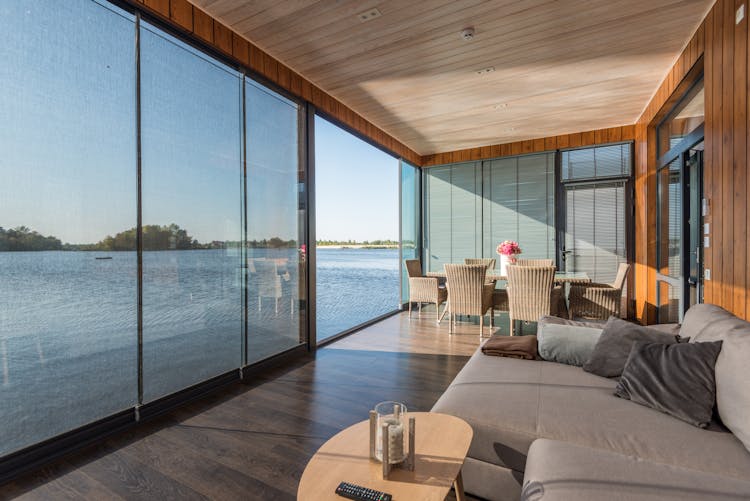 Living Room With Glass Doors Opening To Water