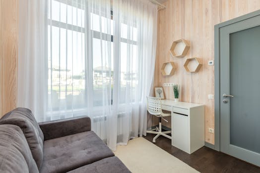 Bright modern room with a minimalist desk and window view, accentuated by natural light.