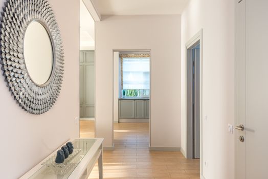 Minimalist interior hallway with wall art and natural light. Modern design.