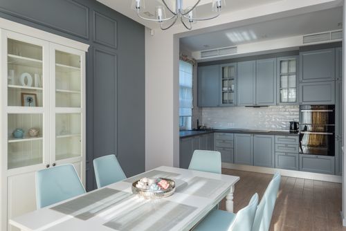 Free Chic dining room with pastel chairs and grey kitchen cabinets. Perfect for modern interior design inspiration. Stock Photo