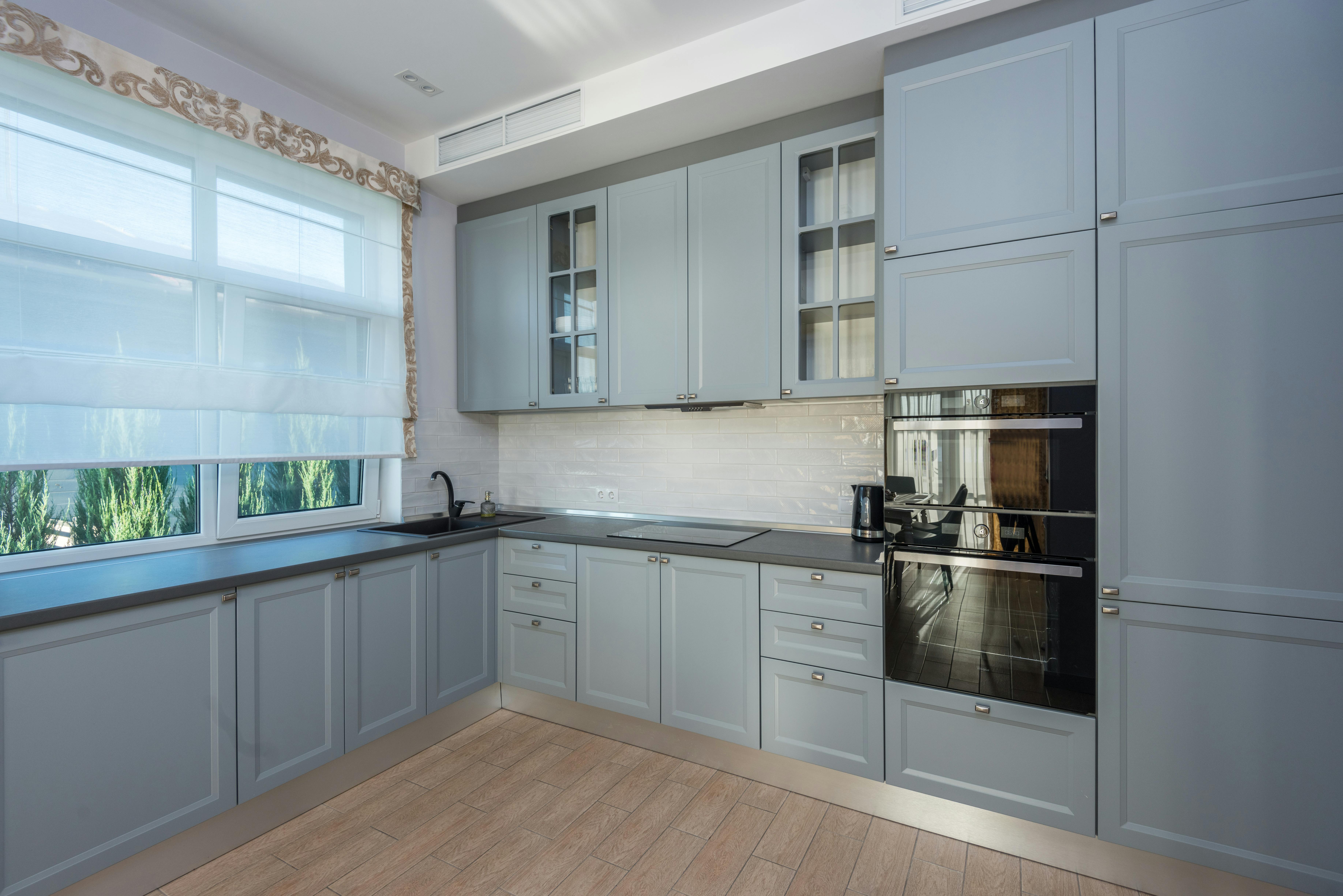 empty kitchen with gray cupboards for rent