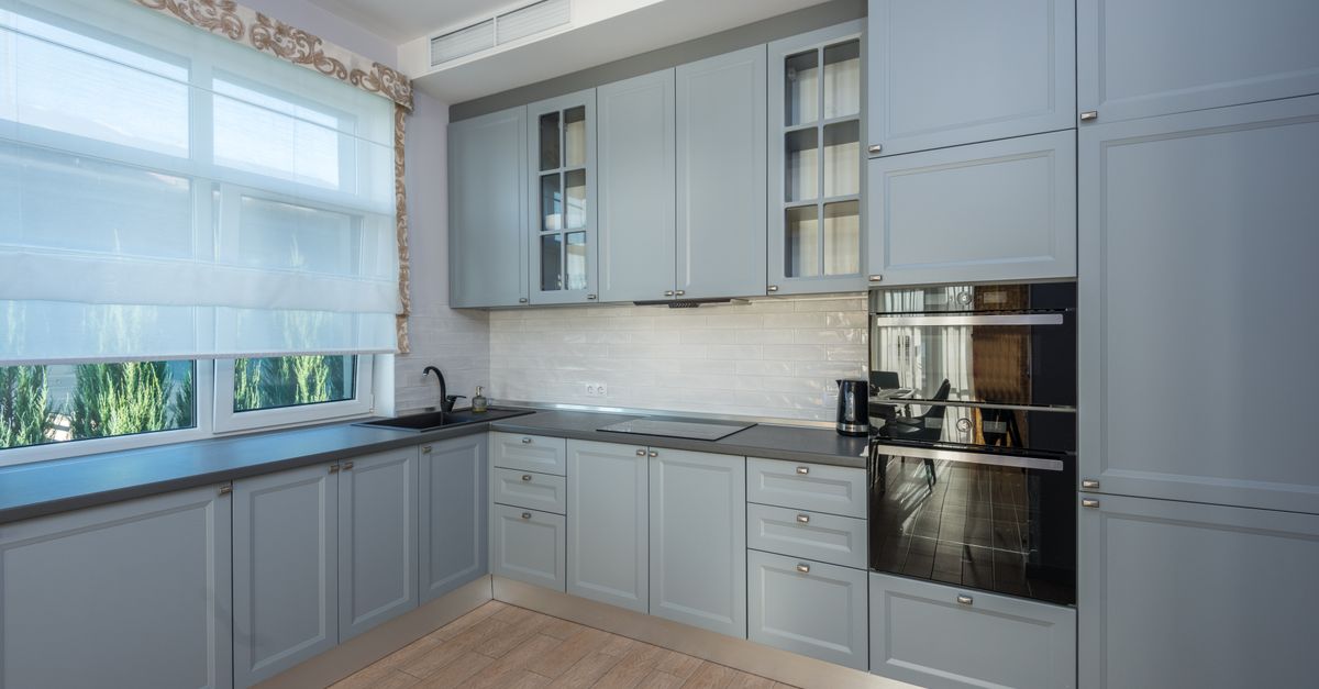 Spacious kitchen with modern cabinetry and large windows for ample natural light.