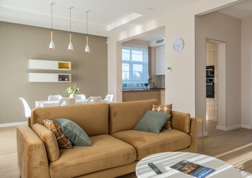 A Brown Couch with Pillows Near the Center Table