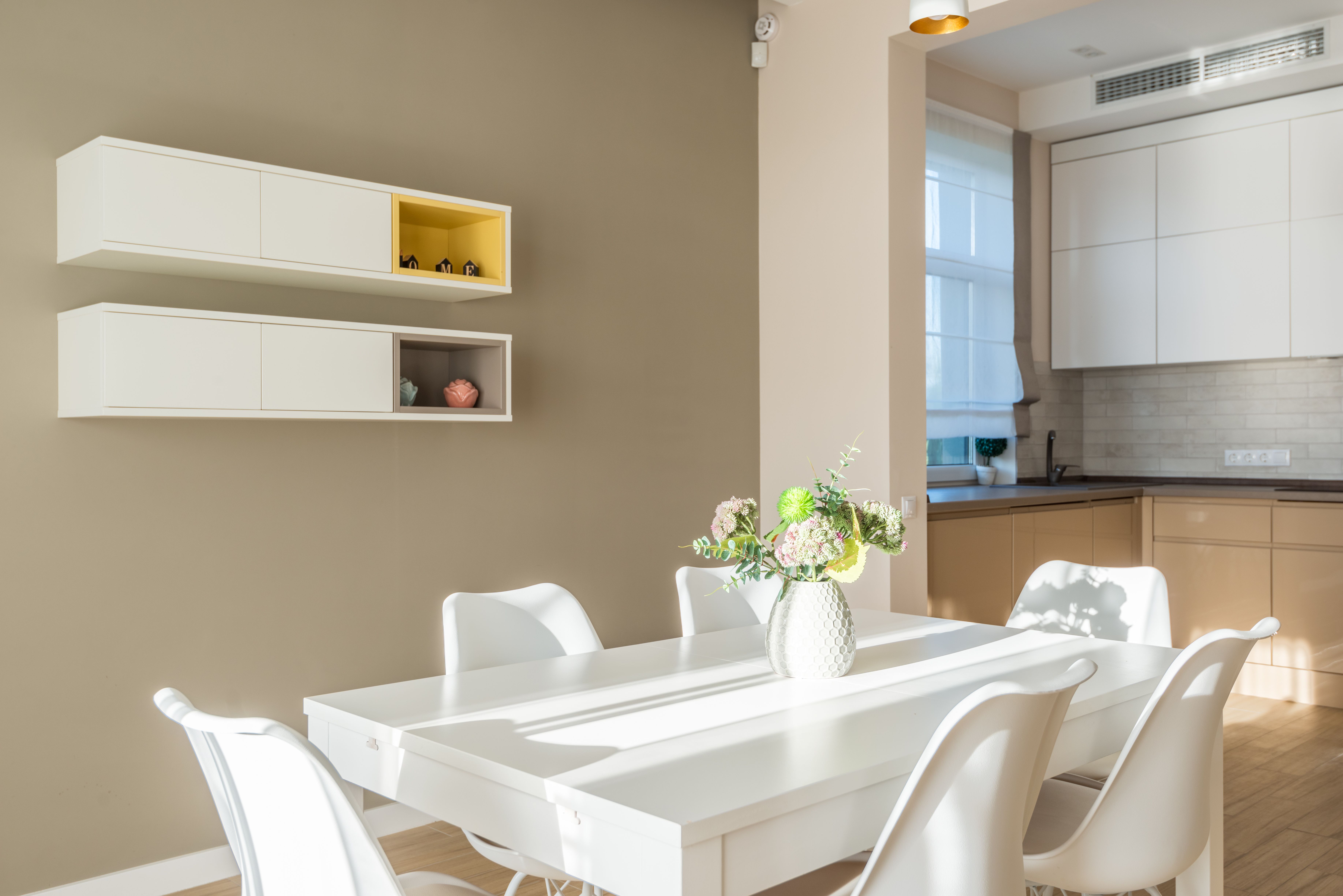 Stylish dining nook with neutral tones and natural daylight