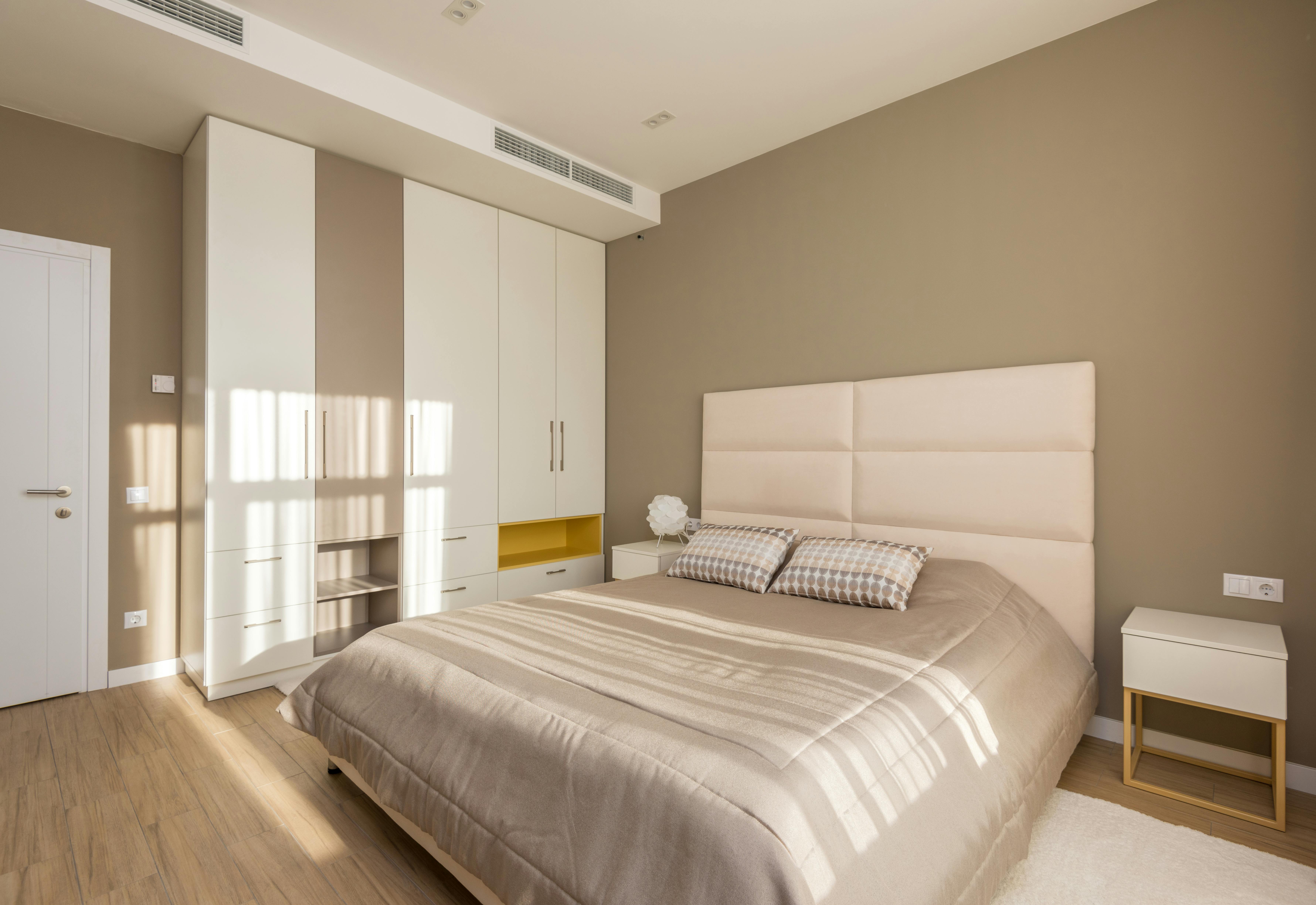 Front of zip tote bag with white canvas, black canvas straps and handle, and black zipper pulls.