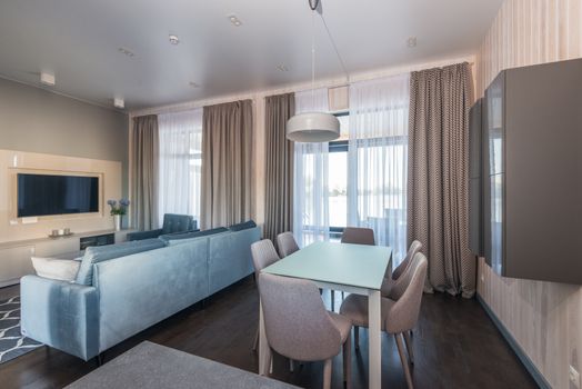Elegant living and dining space featuring contemporary furnishings and natural light.