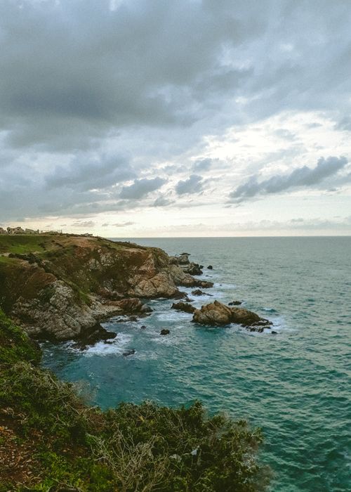 Free A dramatic view of El Marsa's rocky coastline under an overcast sky in Algeria. Stock Photo