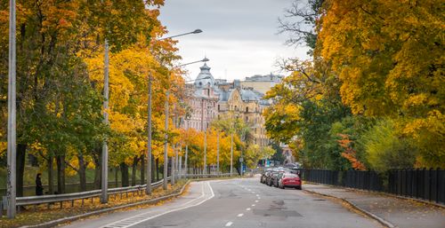 Free Charming autumn cityscape with tree-lined avenue and historic architecture. Stock Photo