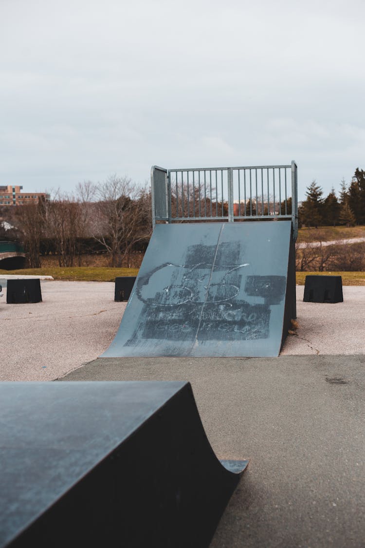 Ramp On Playground Near Road And Trees Under Sky