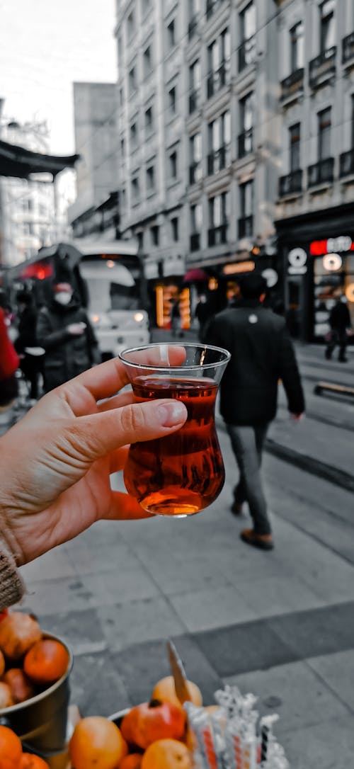A Person Holding a Turkish Tea Glass