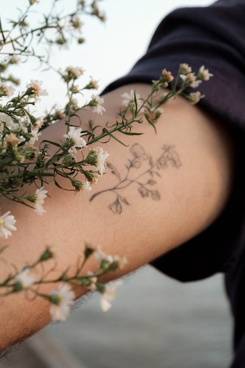 Close Up Shot of a Flower and Tattoo Flower