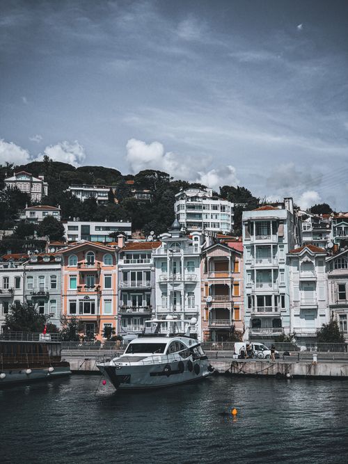 Free A picturesque scene of colorful buildings and docked yachts along the vibrant waterfront of Arnavutköy, Istanbul. Stock Photo
