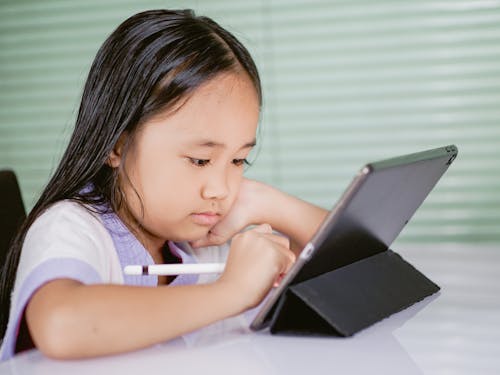 Free A Girl Using a Tablet Computer Stock Photo