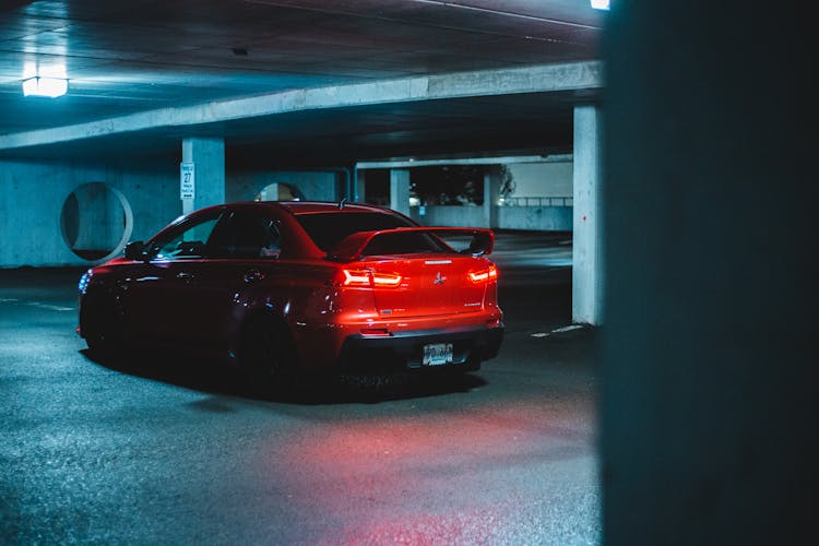 A Red Mitsubishi Lancer Evo In A Parking Garage