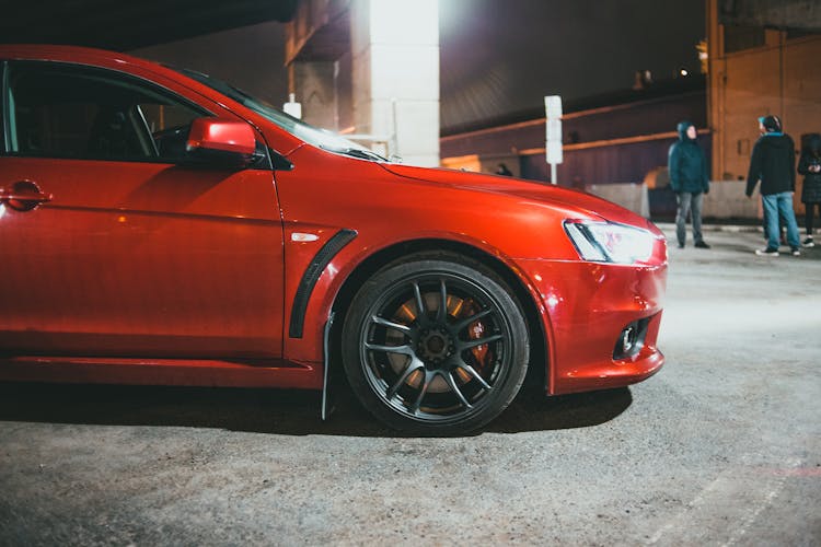 Red Car Parked On Gas Station