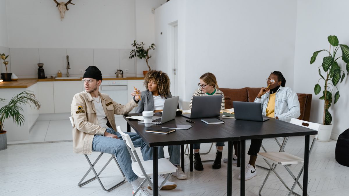 A diverse group of professionals collaborating in a modern and stylish office setting.