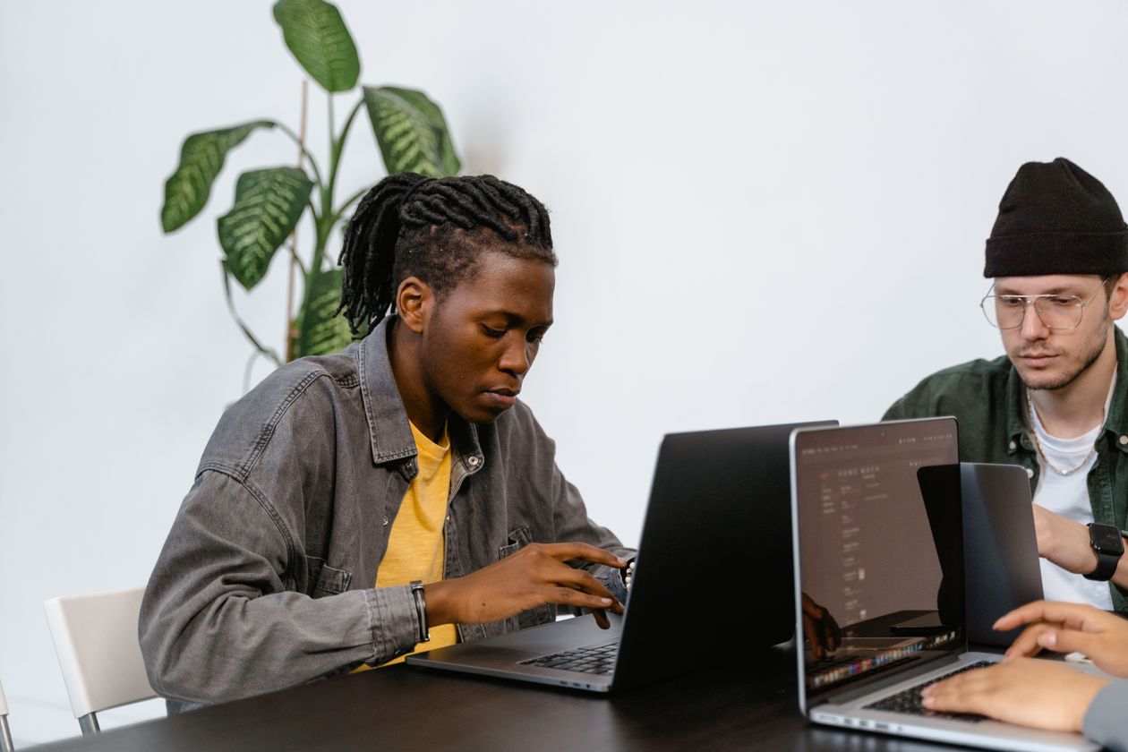 Two young adults working on laptops