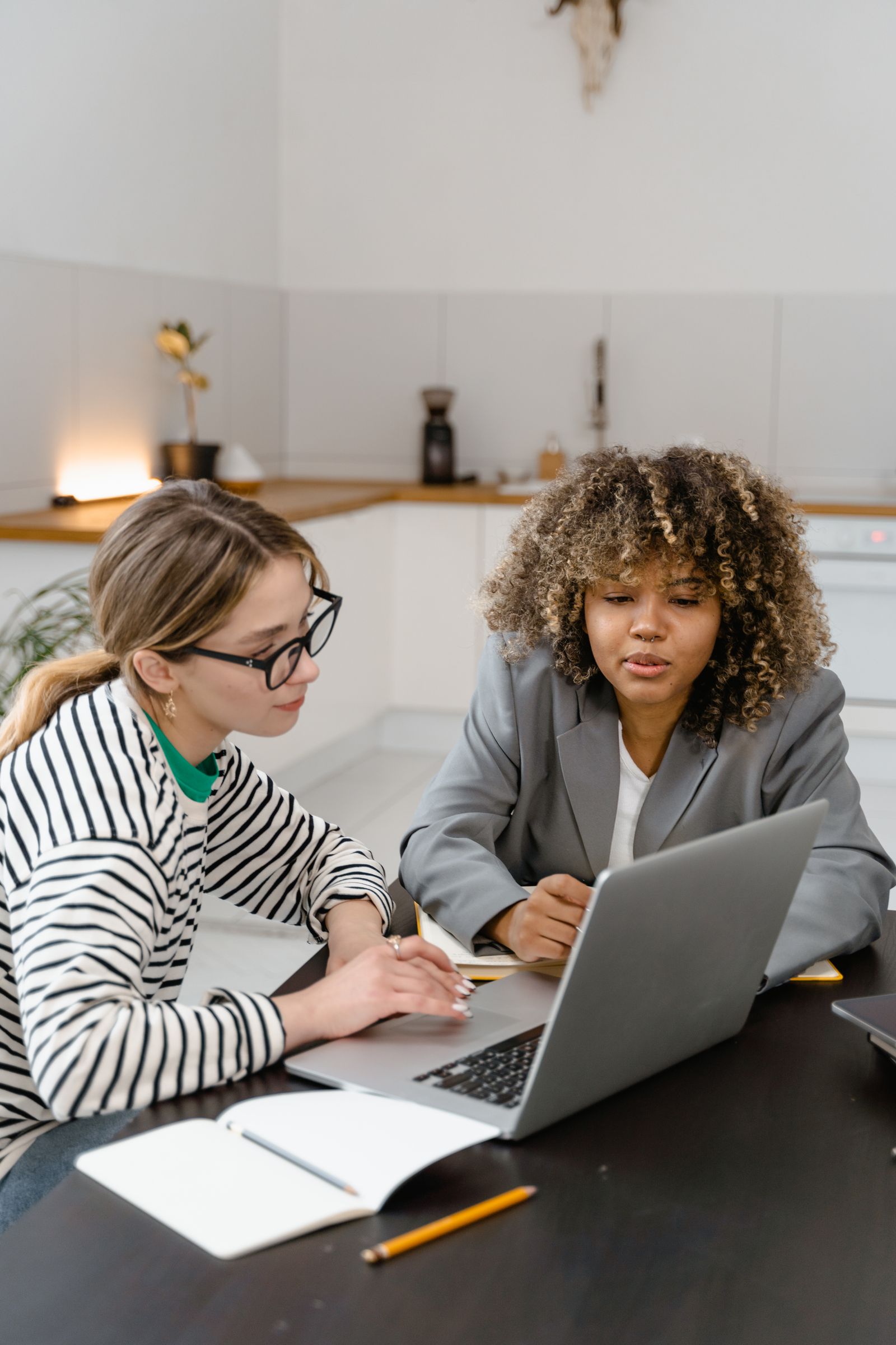 Business team brainstorming a marketing strategy together around a laptop