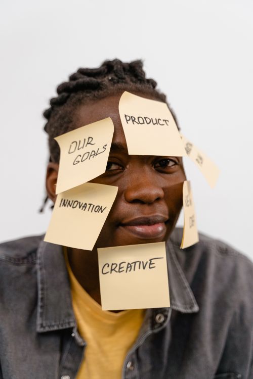 Free African American man with motivational sticky notes on his face. Creative idea concept. Stock Photo