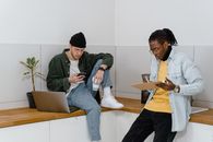 Man in Blue Denim Jacket Sitting on Gray Chair