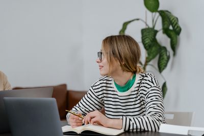 Learner taking notes at a desk, photo by MART PRODUCTION on Pexels