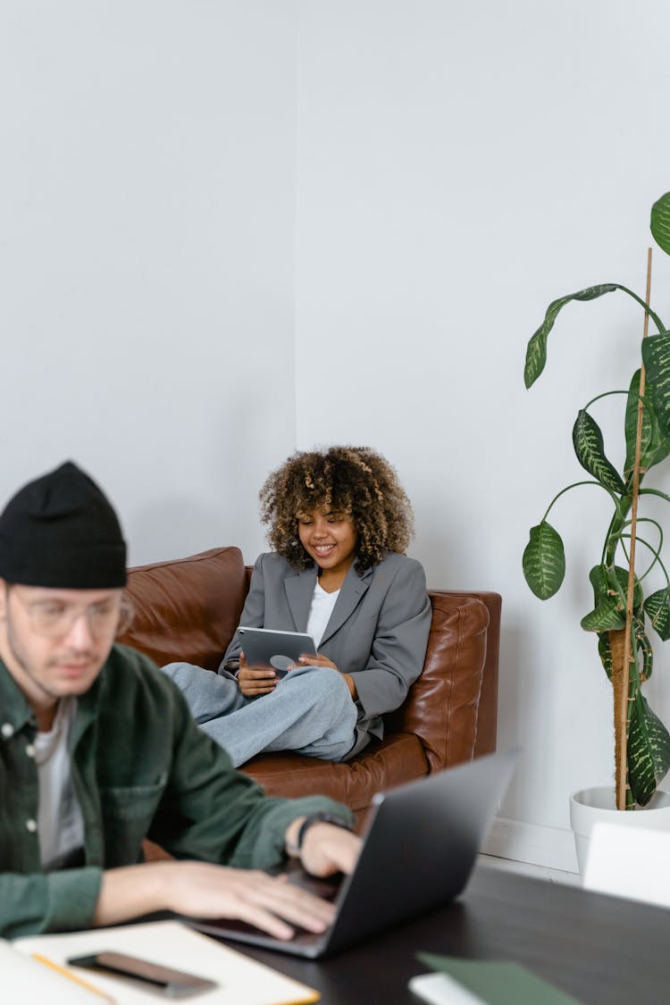 Woman Smiling While Looking At The Ipad 