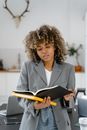 Woman in Gray Blazer Holding Book