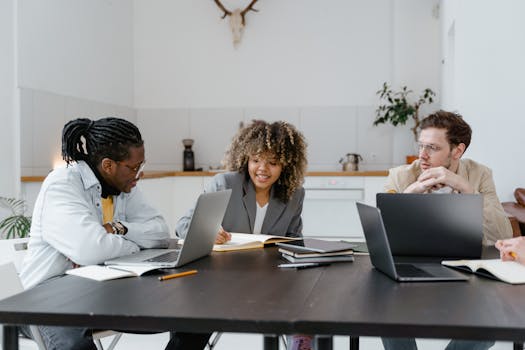 A group of professionals engaging in a creative meeting within a contemporary office setting.