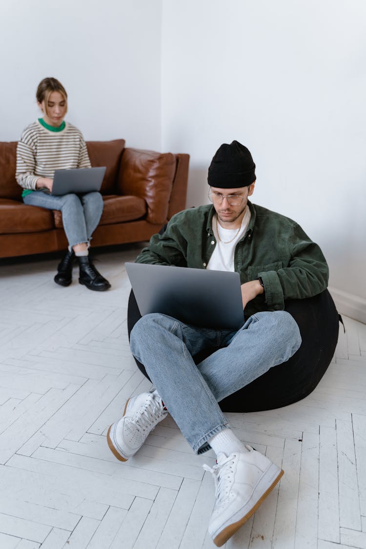 Man Sitting On Bean Bag With Laptop